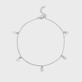 Silver anklet with small round pendants on a light gray background
