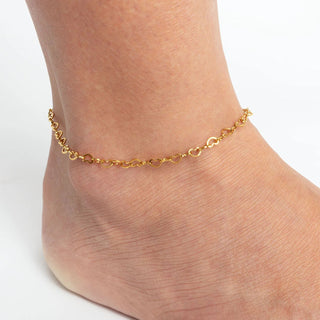 Gold Linked Hearts Anklet on a person's ankle against a white background
