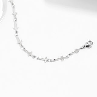 Silver cross bracelet with cross designs on a white background