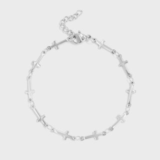 Silver bracelet with cross designs on a light gray background