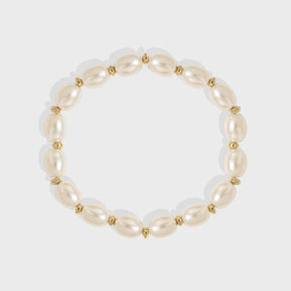 Pearl bracelet with gold accents on a white background