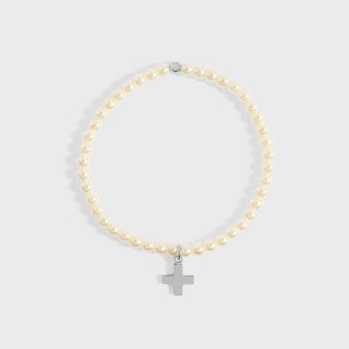 Pearl bracelet with a silver cross charm on a light gray background