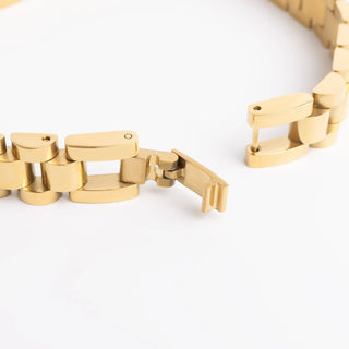 Gold chain bracelet on a white background