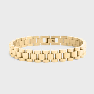 Gold bracelet on a light gray background