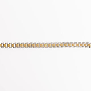 Two-tone gold bracelet on a white background