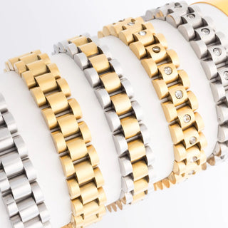 Gold and silver watch bracelets on a white background