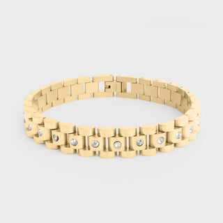Gold bracelet with embedded diamonds on a light gray background