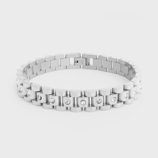 Silver bracelet with embedded stones on a light gray background