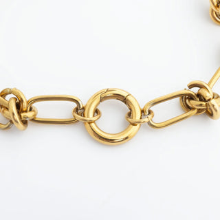 Gold chain bracelet on a white background