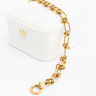 Gold chain bracelet on a white background
