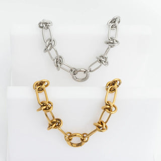 Gold and silver chain bracelets on a white background