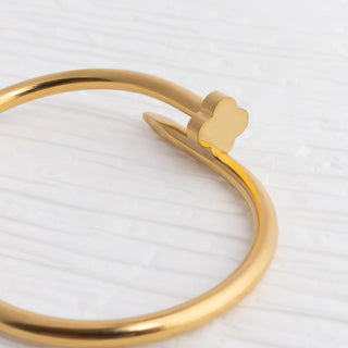 Gold bracelet with a heart-shaped clasp on a white background