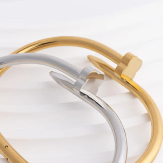 Close-up of a gold and silver bracelet on a white background
