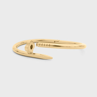 Gold bracelet on a light gray background