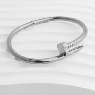 Silver bracelet on a light gray background