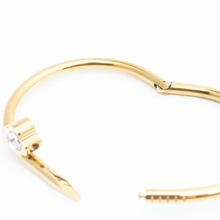 Gold bracelet with a small pearl on a white background