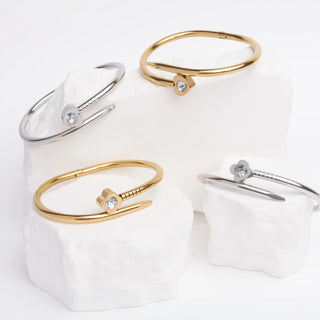 Set of gold and silver bangle bracelets on a white background
