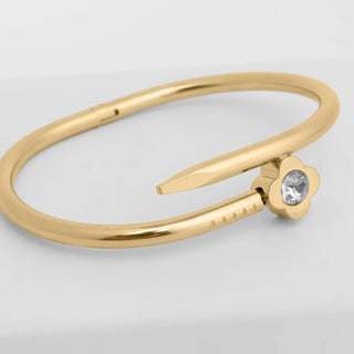 Gold ring with a small diamond on a light gray background