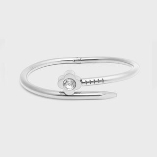Silver bracelet with a small gemstone on a light gray background
