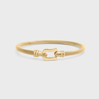 Gold bracelet with a clasp on a light gray background