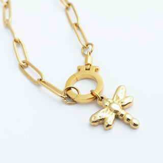 Gold chain necklace with a bow-shaped pendant on a white background