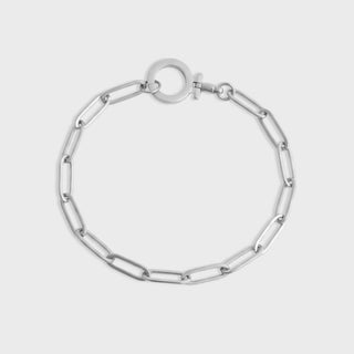 Silver chain bracelet on a light gray background