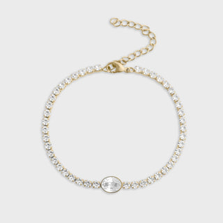 Gold bracelet with clear gemstones on a light gray background