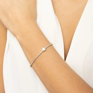 Pearl bracelet on a person's wrist against a white background