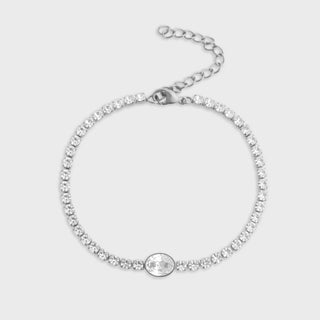 Silver bracelet with clear gemstones on a light gray background