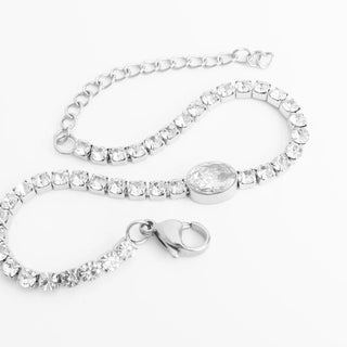 Silver bracelet with clear crystals on a white background