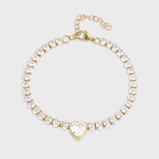 Gold and crystal bracelet on a light gray background