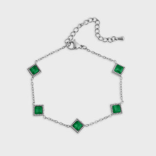 Silver bracelet with green gemstones on a white background