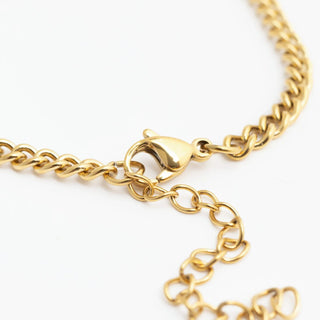 Gold chain bracelet on a white background