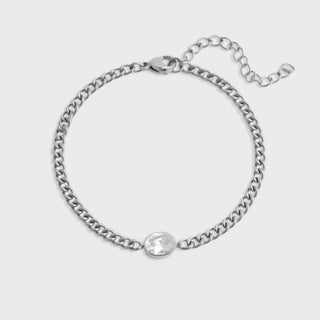 Silver chain bracelet on a light gray background