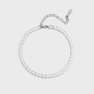 Silver bracelet with clear gemstones on a light gray background