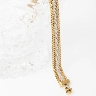 Gold chain bracelet with a clasp on a white background