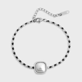 Silver bracelet with black beads on a white background