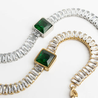 Two bracelets with green gemstones and clear stones on a white background