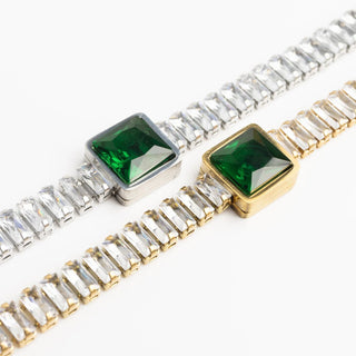 Two bracelets with green gemstones and clear stones on a white background