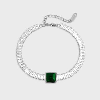 Silver bracelet with a green gemstone on a white background