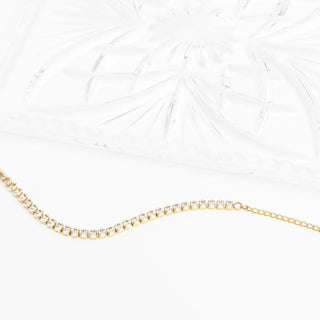 Gold chain necklace on a white background