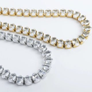 Two gold and silver beaded bracelets on a white background