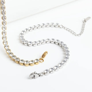 Two necklaces, one gold and one silver, on a white background