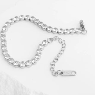 Silver bracelet with clear stones on a white background