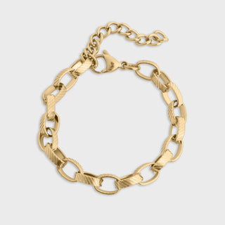Gold chain bracelet on a light gray background