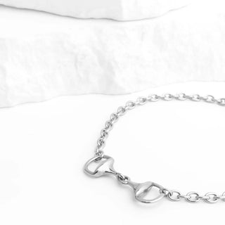 Silver bracelet with a horse bit design on a white background