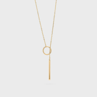 Gold necklace with circular lariat pendant on a white background
