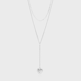 Silver heart-shaped pendant necklace on a light gray background