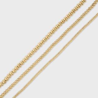 Gold beaded chain on a light gray background