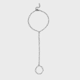 Silver hand chain on a light gray background